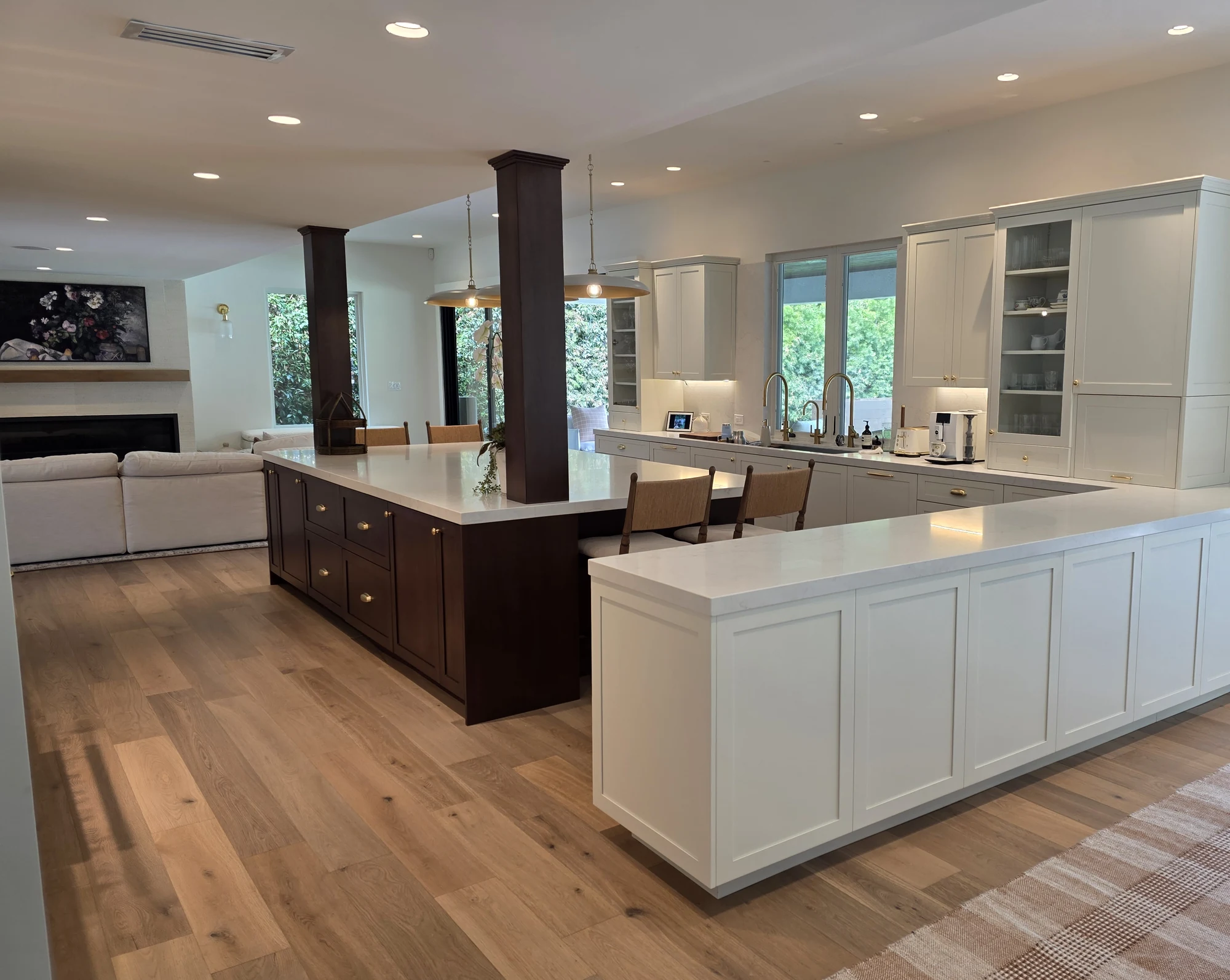 Walnut island and ivory cabinetry opening toward the garden